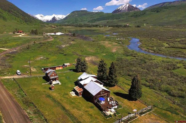 aerial view with a water and mountain view and a rural view