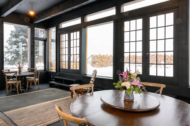 sunroom featuring a healthy amount of sunlight and beamed ceiling