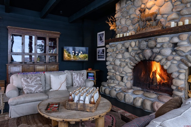 living room with hardwood / wood-style flooring, beamed ceiling, and a fireplace