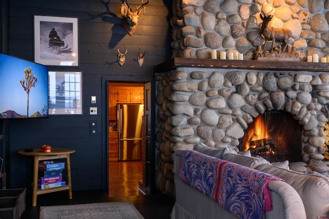 living room with hardwood / wood-style flooring and an outdoor stone fireplace