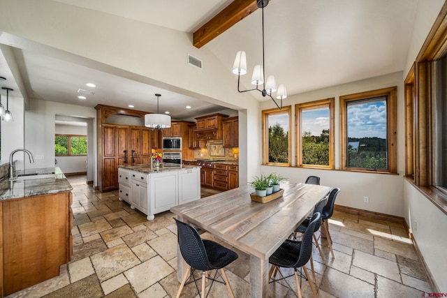 dining room with sink, an inviting chandelier, and plenty of natural light