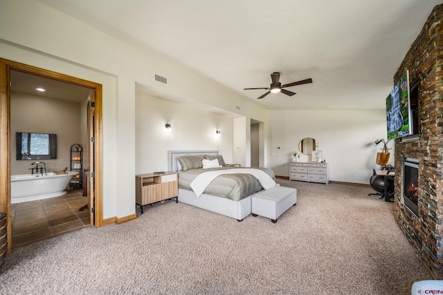 carpeted bedroom featuring lofted ceiling, a brick fireplace, and ceiling fan