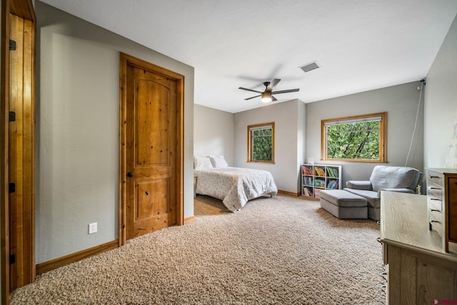 bedroom featuring carpet floors, baseboards, and a ceiling fan