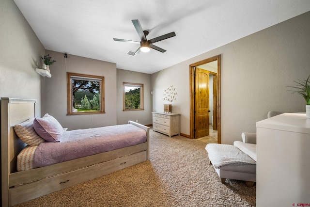 bedroom featuring ceiling fan and light carpet