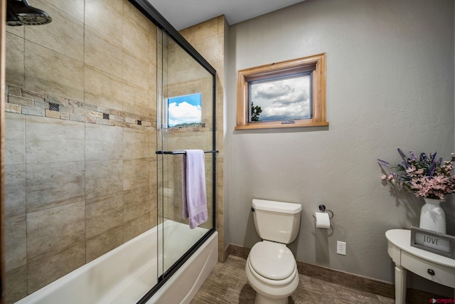 bathroom with toilet, combined bath / shower with glass door, and wood-type flooring