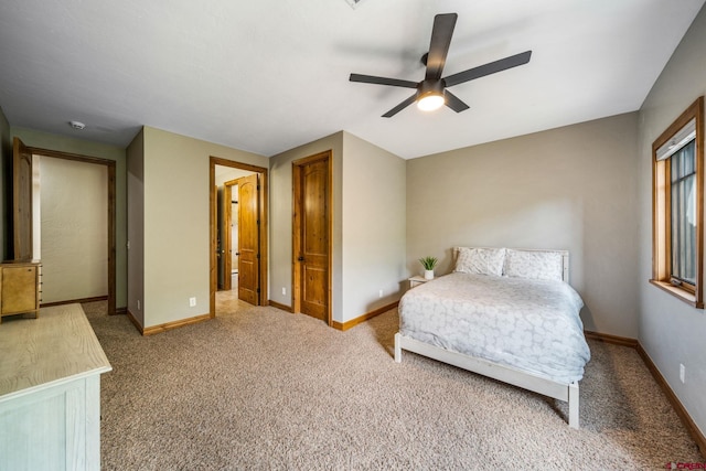 carpeted bedroom featuring baseboards and ceiling fan
