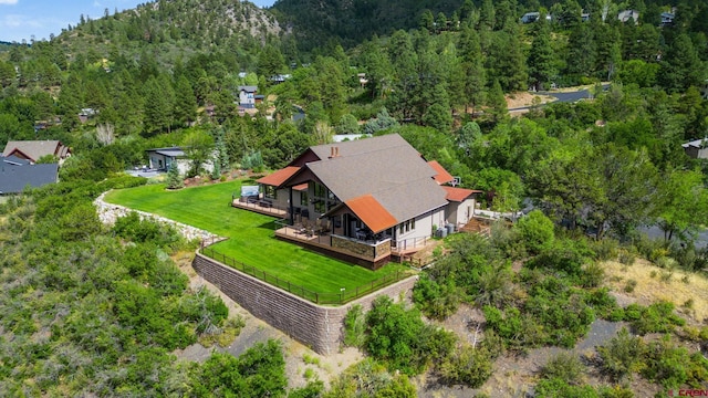view of subject property with a heavily wooded area