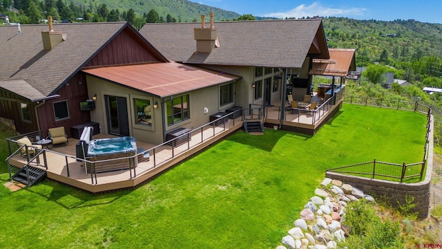 back of house with an outdoor living space, a wooden deck, and a lawn