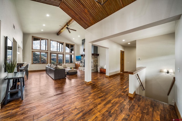 living room with dark hardwood / wood-style floors, beam ceiling, a fireplace, high vaulted ceiling, and ceiling fan