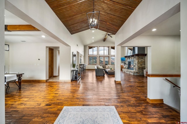 living room with a fireplace, dark hardwood / wood-style flooring, beamed ceiling, high vaulted ceiling, and an inviting chandelier