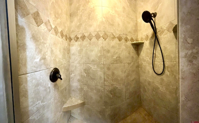 interior details with a tile shower