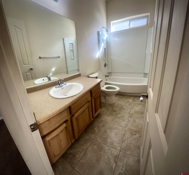 full bathroom featuring washtub / shower combination, tile patterned floors, vanity, and toilet