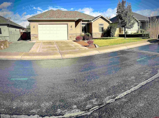 ranch-style house featuring a front yard and a garage