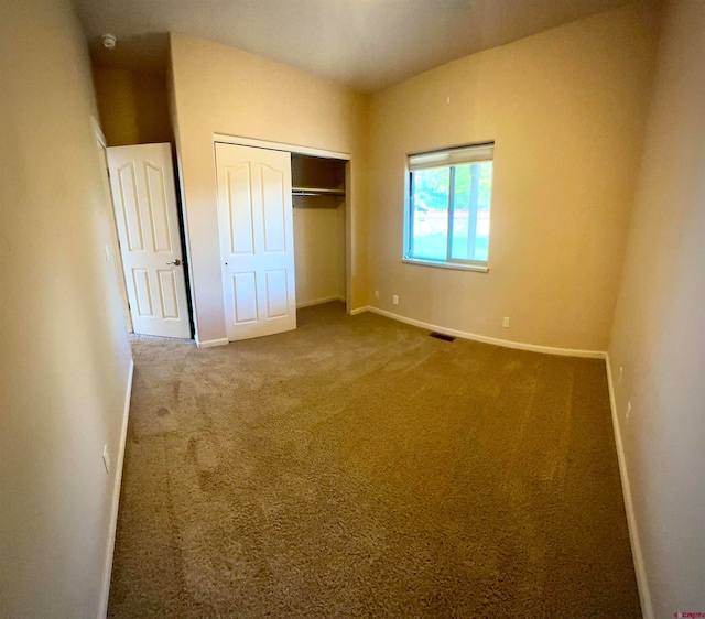 unfurnished bedroom with a closet and carpet