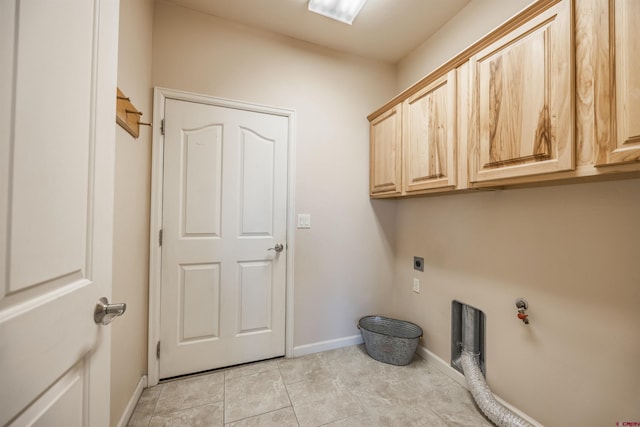 washroom with light tile patterned flooring, cabinets, and hookup for an electric dryer