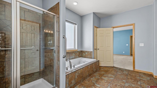 bathroom featuring a wealth of natural light and shower with separate bathtub