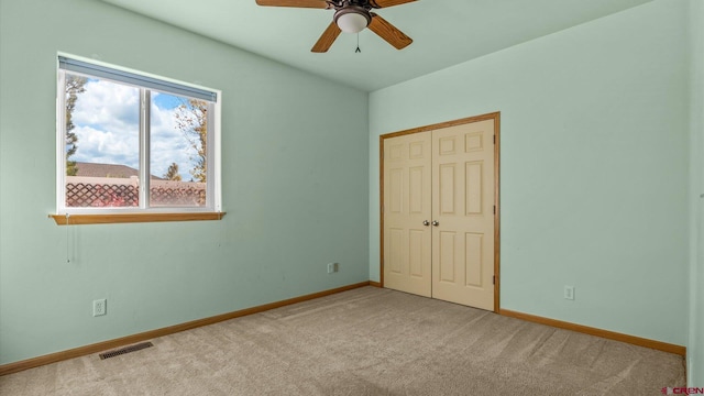 unfurnished bedroom with a closet, ceiling fan, and light colored carpet