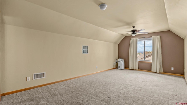 additional living space with carpet floors, ceiling fan, and vaulted ceiling