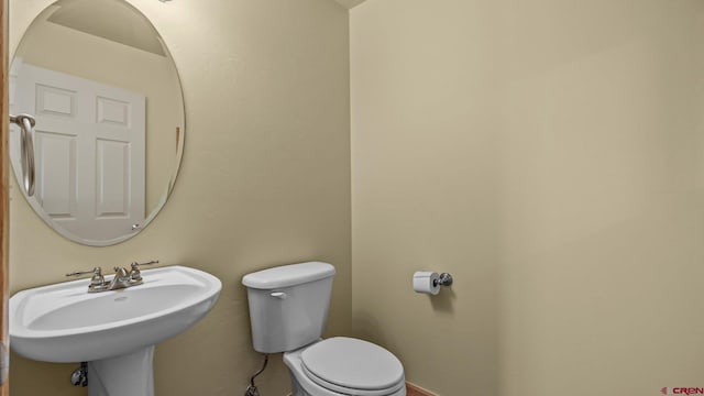 bathroom featuring sink and toilet