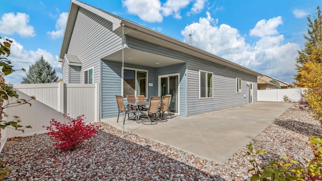 back of property with a patio