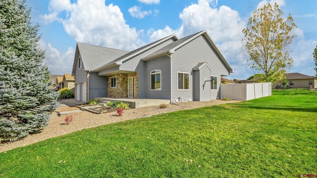 exterior space featuring a garage and a lawn