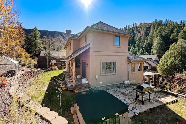 back of house with a patio area and a mountain view