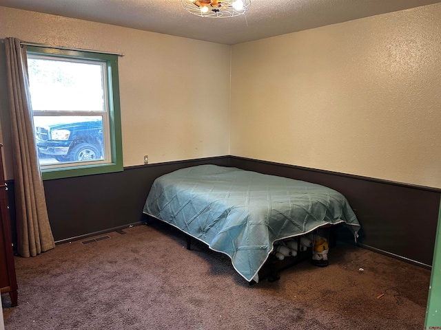 bedroom with a textured ceiling and carpet floors