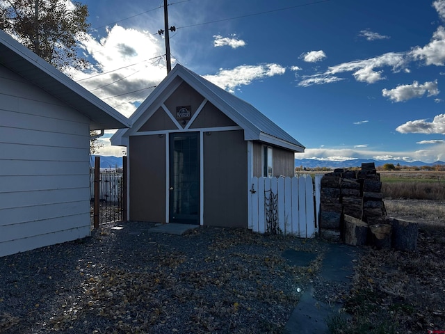 rear view of house featuring a mountain view and an outbuilding