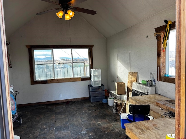 interior space with ceiling fan and vaulted ceiling