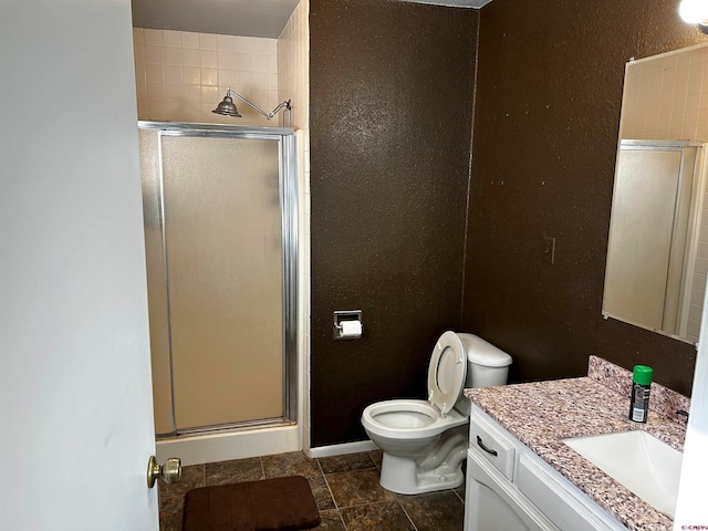 bathroom with vanity, toilet, and walk in shower