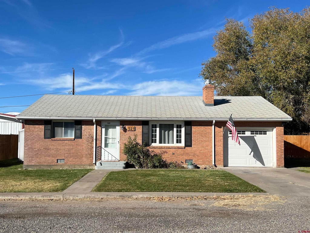 ranch-style home with a front yard and a garage