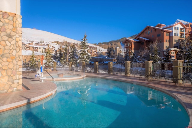 view of swimming pool with a mountain view