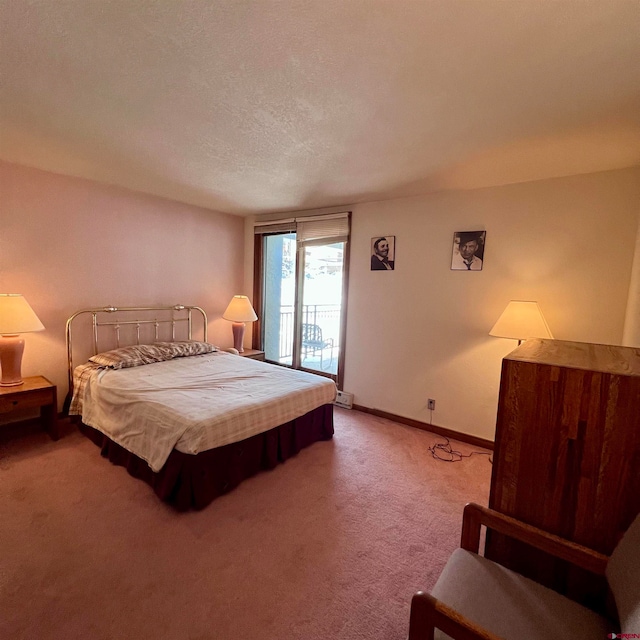 carpeted bedroom featuring a textured ceiling and access to exterior