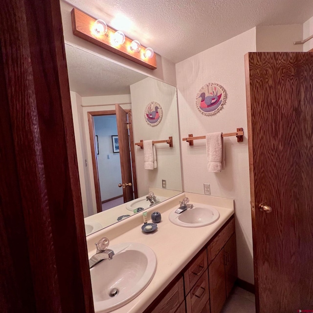 bathroom with vanity and a textured ceiling