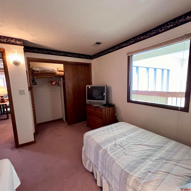 carpeted bedroom with a closet