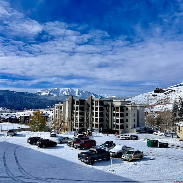 snow covered building with a mountain view