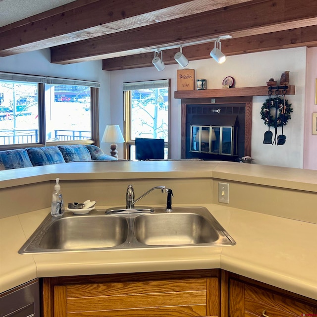 kitchen with beam ceiling and sink