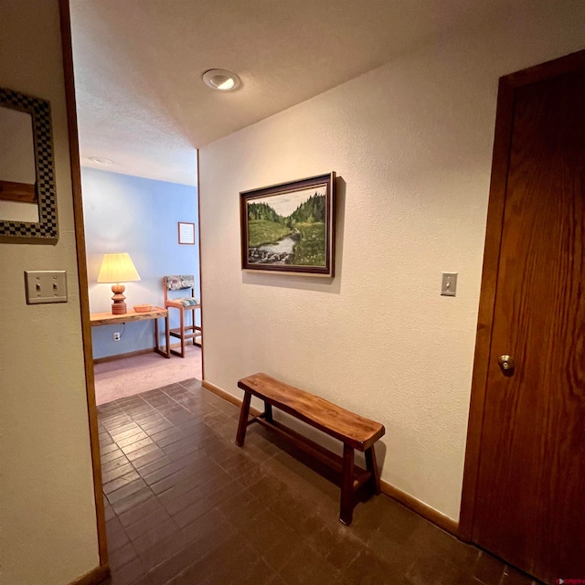 corridor featuring dark tile patterned floors