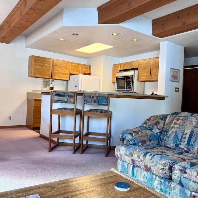 living room featuring beam ceiling and light hardwood / wood-style flooring