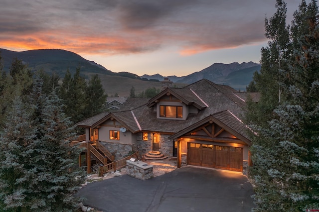 view of front facade with a garage and a mountain view