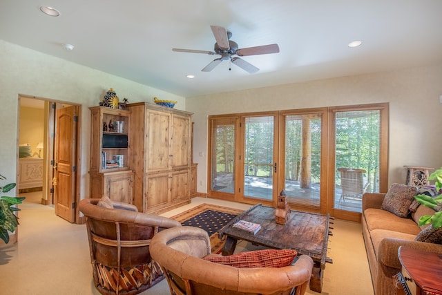 living room featuring light carpet and ceiling fan