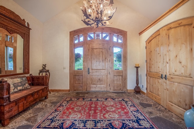 foyer with vaulted ceiling and an inviting chandelier