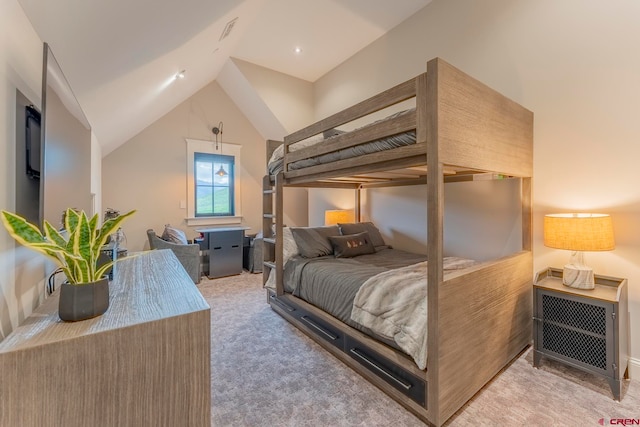 carpeted bedroom featuring heating unit and lofted ceiling