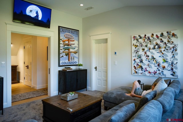 living room featuring hardwood / wood-style floors and vaulted ceiling