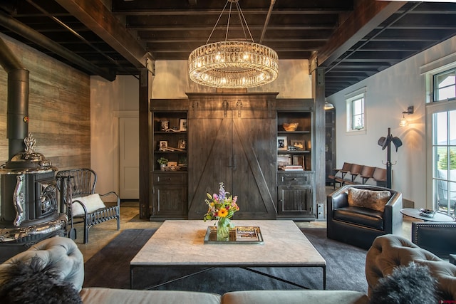 living room with a wood stove, wood walls, and beamed ceiling