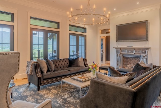 living room featuring hardwood / wood-style floors, french doors, a notable chandelier, and crown molding