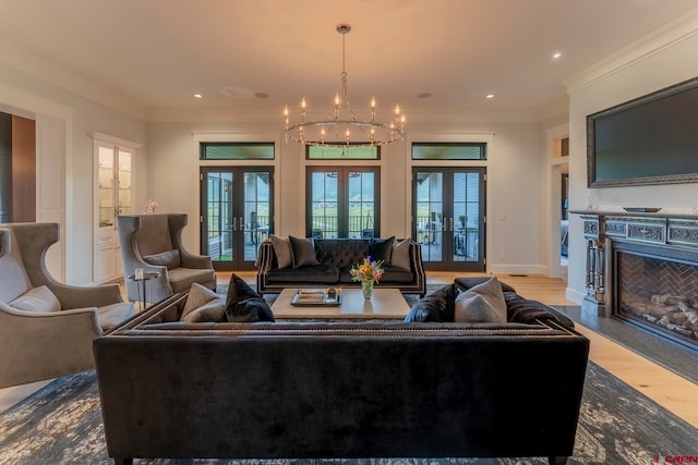 living room with french doors, crown molding, a notable chandelier, and wood-type flooring