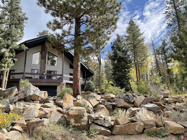 1660 Lake Purgatory Dr, Durango, CO 81301 - view of side of property featuring stucco siding and a wooden deck