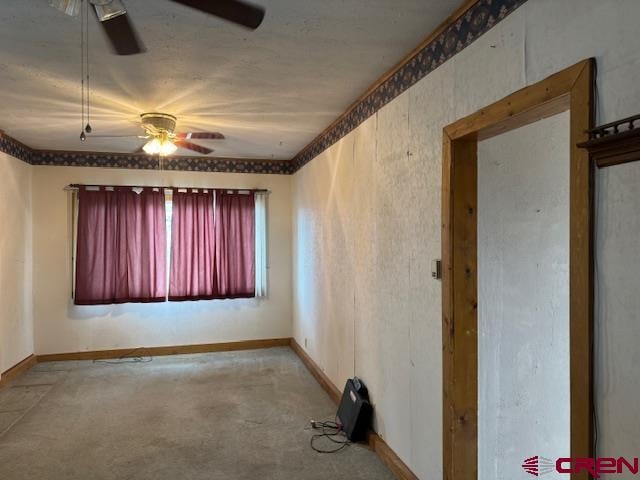 carpeted spare room featuring ceiling fan