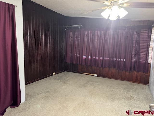 empty room with light carpet and ceiling fan